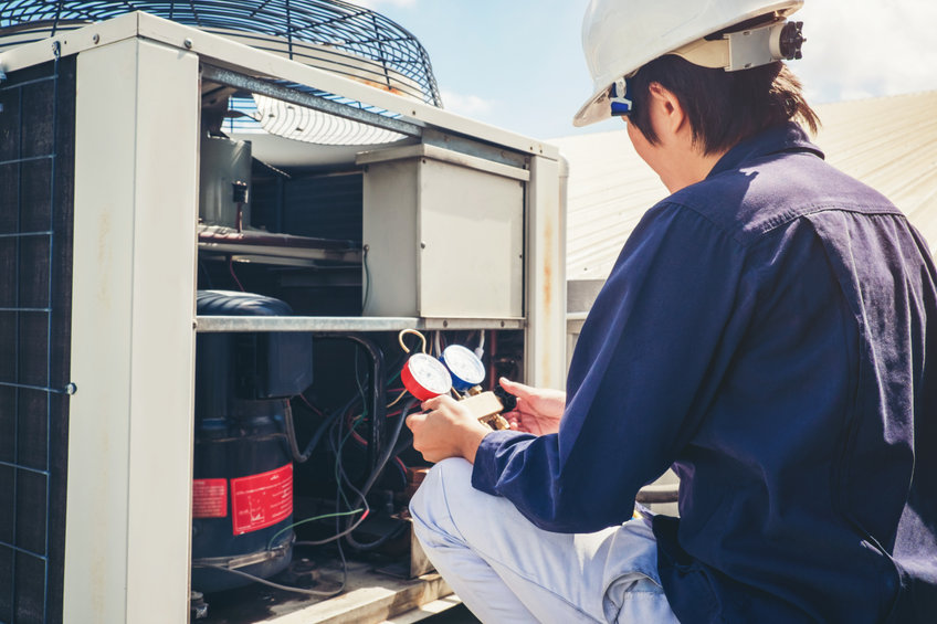 Technician is checking air conditioner